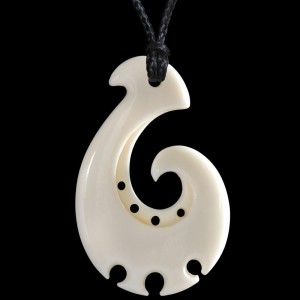 A hand carved bone fish hook necklace