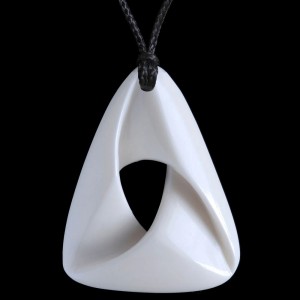 A hand crafted mobius ribbon bone carving necklace.