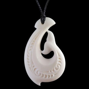 A hand crafted and engraved whale tail Matau bone carving necklace